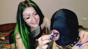 Smoking fetish. Dominatrix shakes cigarette ash on her slave&#039;s head and mouth.