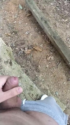 Cumming behind collapsed barn in the woods