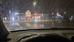 Sarah Struggling to Start Her Car in a Busy Parking Lot on a Rainy Night