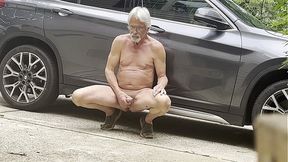 Cougar man wanks his cock in public car parking