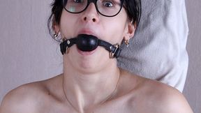 Ballgagged nude barefoot Alberta, wearing only eyeglasses, bound standing to the wooden post with crossbar, struggles and moans (HD WMV)