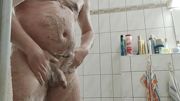 Guy in the shower plays with his cock and balls