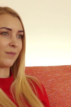 classy blonde sits on the sofa exposing her sexy legs