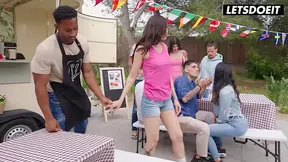 Tattooed brunette gives a sloppy public blowjob to a black guy at a BBQ party.