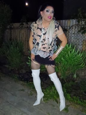 Cigarette break of a pretty mature transvestite slut in the garden in thigh-high boots and pantyhose