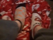 Tiny feet in mix match socks rubbing blanket
