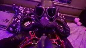 Femboy in a rubber latex suit and gas mask with big cock