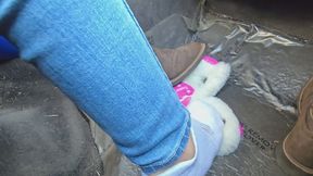 Chrissy taking off one boot in car