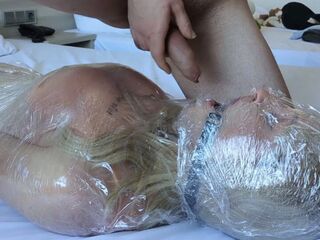 Cute Transsexual wrapped in plastic! Thrashing! Spunk fountain in her throat! Used til this babe cums!