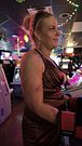 Stepmom in mini dress pounding bag as hard as she can at the video arcades on date night