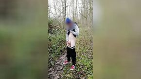 Boy jerking off and cumming on a forest trail