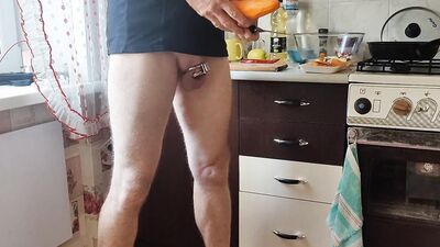 Guy with locked cock is in the kitchen