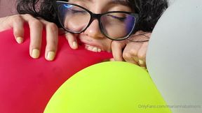 Marianna bites and pops her balloons