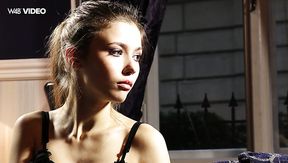 Fine young white girl in black lingerie undresses and poses on the couch