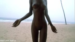 Skinny ebony nymph dances in the rain, teasing with her slim body
