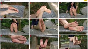 My mature, charming, and sexy female leader, Jun Jun, displayed her beautiful and moist feet on a stone table in the park.
