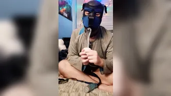 Solo guy in chastity cage plays with glass dildo