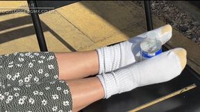 Amelie wearing white gold toe socks playing with a bottle