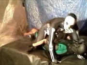 fantasy scene where spandex skeleton wrestles and humps frogman