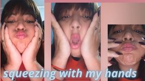 Squeezing my cheeks with my hands