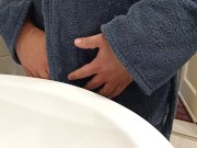 Pissing in the sink wearing a bathrobe.