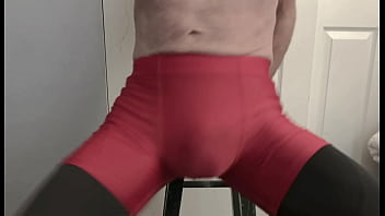 Grinding on Stool in Black Compression Tights and Red Compression Shorts