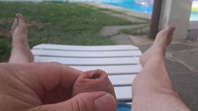 Penis massaging by the pool, with cumshot
