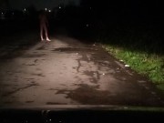 Risky nude on road with car passing