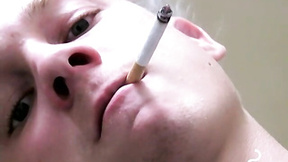 Twink savors the pleasure of smoking & stroking dick