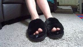 Toe wiggling in plush black slippers (TW)