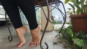 Bare feet with very pronounced arches under a chair (3)