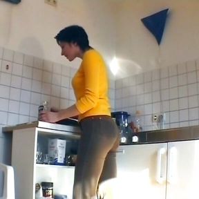 German slut plays with cucumber and sucks dick in the kitchen