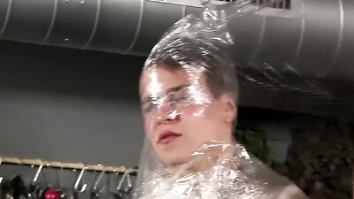 Disciplined twink gets wrapped in plastic by his master