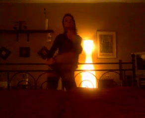 Sensual dark-haired girl strokes her body in front of a webcam