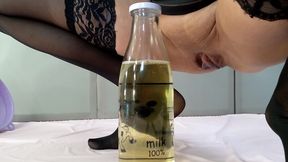 adult with big tits pisses in a bottle through a funnel