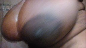 ebony slut with huge tits taking a shower