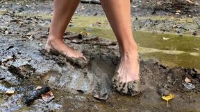 Maria walking barefoot through deep mud and smelly puddles, barefoot in mud, muddy feet