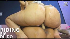 Two salacious slobs engage in a fervent diddle-riding ritual using an enormous double dildo