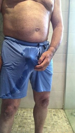 Pissing in blue shorts