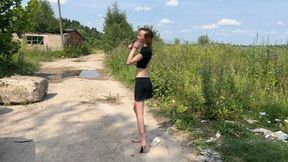 a girl in new high-heeled boots walks through deep puddles, water is poured into the boots