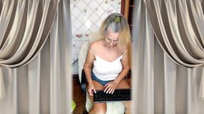 An Elderly Granny with Gray Hair Teases with Her Figure and Legs in the Kitchen.