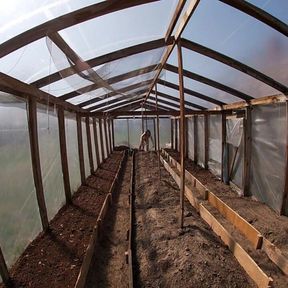 Nude house wife working in the greenhouse