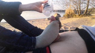 public footjob and socksjob on the beach