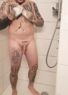 tattooed man in the shower