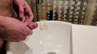 Urinating inwards a used love glove