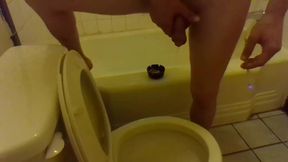 Pissing in the Toilet While Standing on the Bathtub