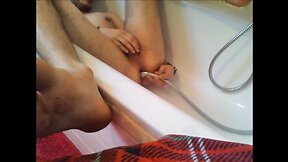 Bi-guy using shower head, squirting water, enema