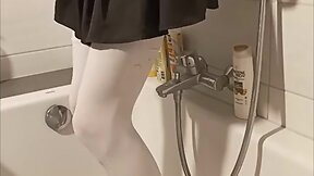 Trans person pisses pantyhose, licks wet feet and fucks self with fat dildo