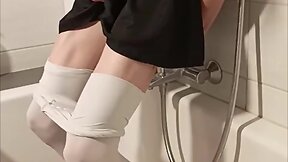 Trans person pisses pantyhose, licks wet feet and fucks self with fat dildo