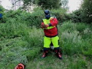 Forest Worker Pup pawing off in gear and boots (outdoors)